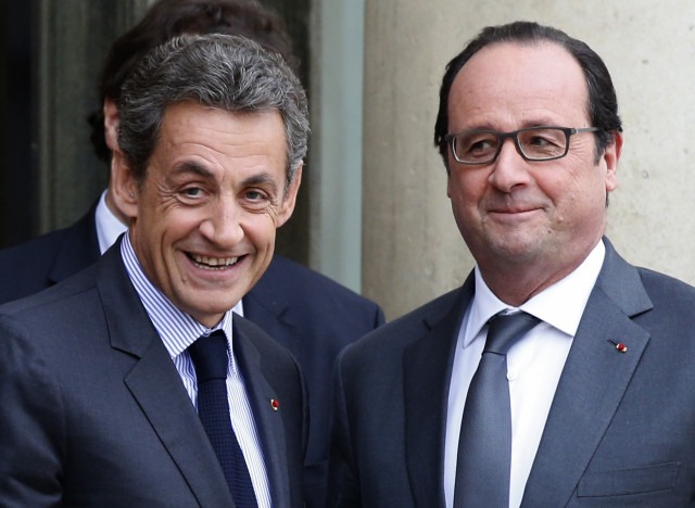 French President Hollande stands with Sarkozy, former president and current head of the Les Republicains political party at the Elysee Palace in Paris